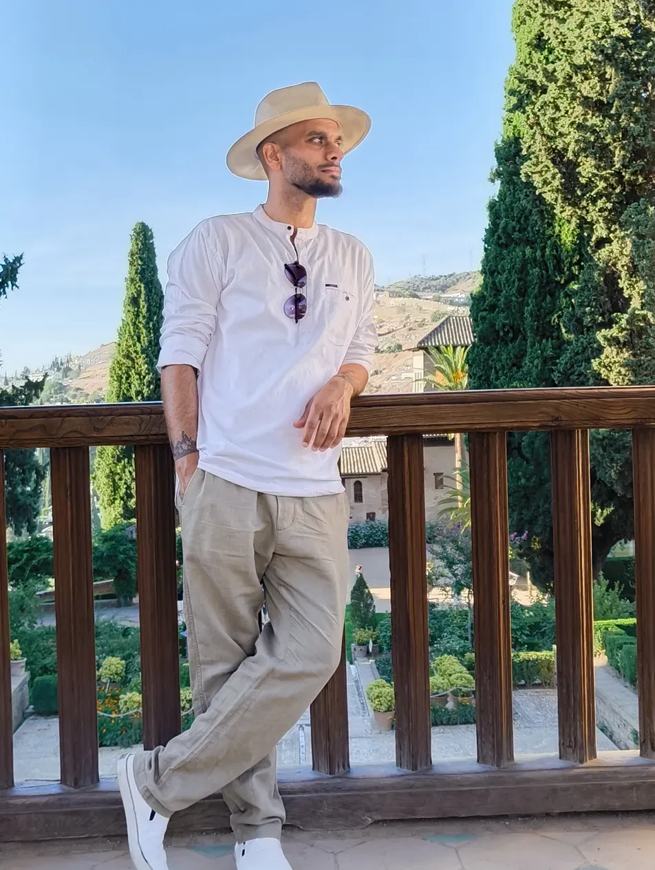 Akhil standing on an Alhambra balcony overlooking gardens